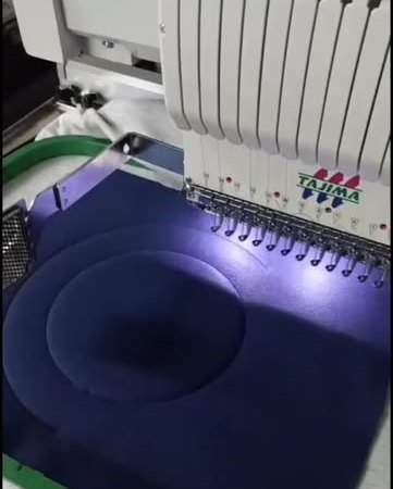 The studio's own Tajima industrial machine in use.