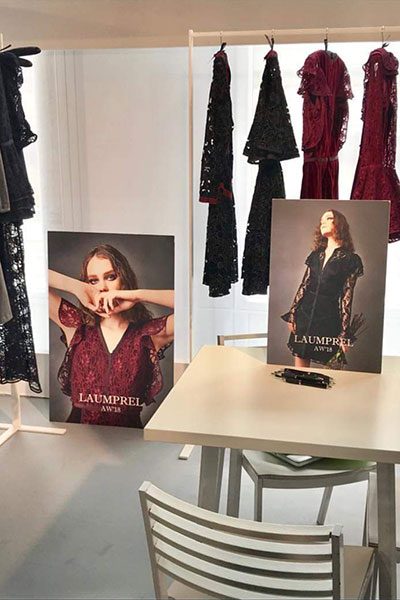 Laumprel AW18 samples on a rail beside lookbook boards in the studio.